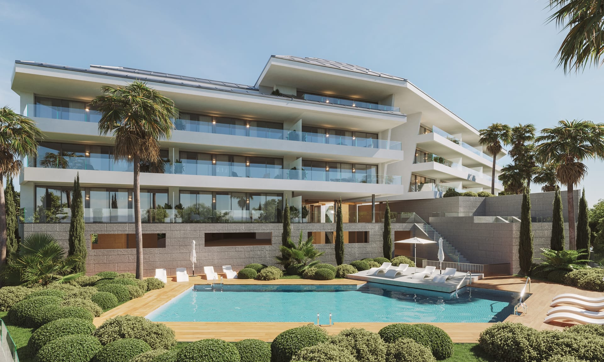 The pool and its sun deck in the gardens in front of the building. Torreblanca Heights, Torreblanca, Fuengirola.