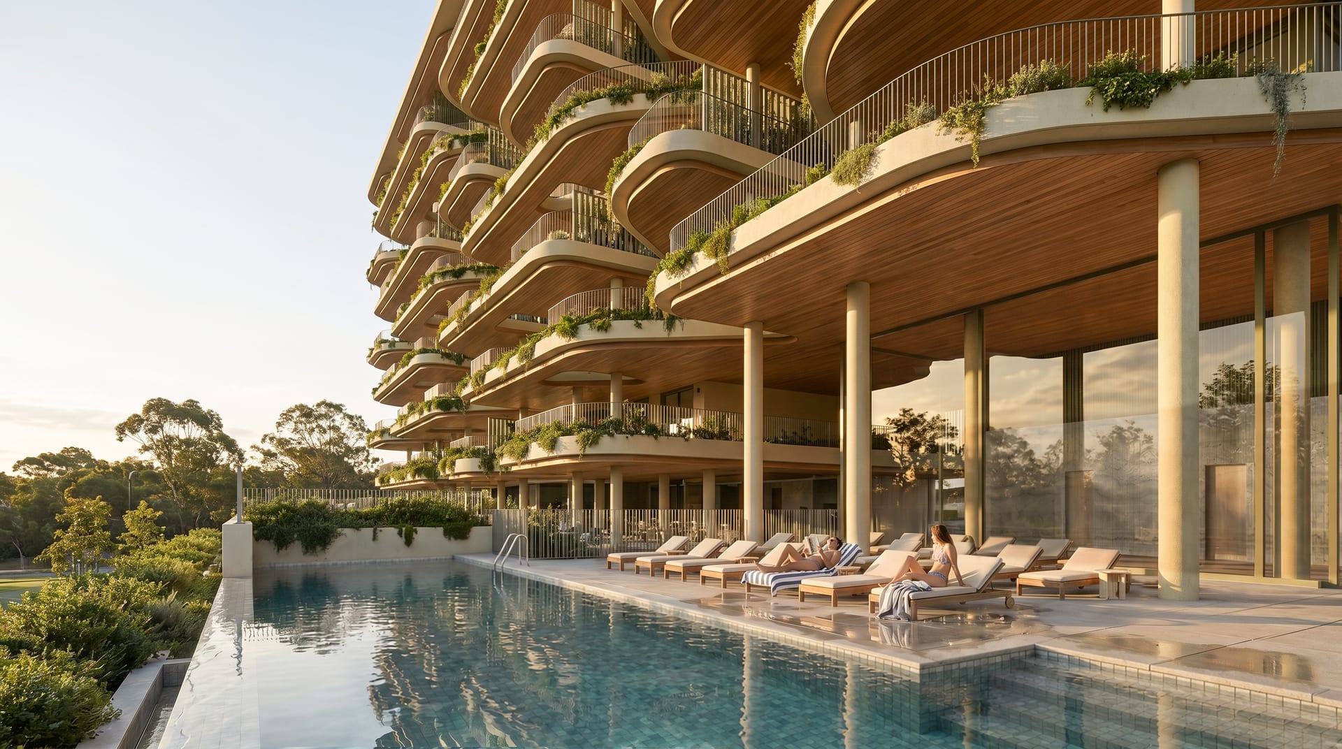 The infinity pool, with loungers along its edge beneath the curved, planted terraces of the building. Vangård, Los Pacos, Fuengirola.