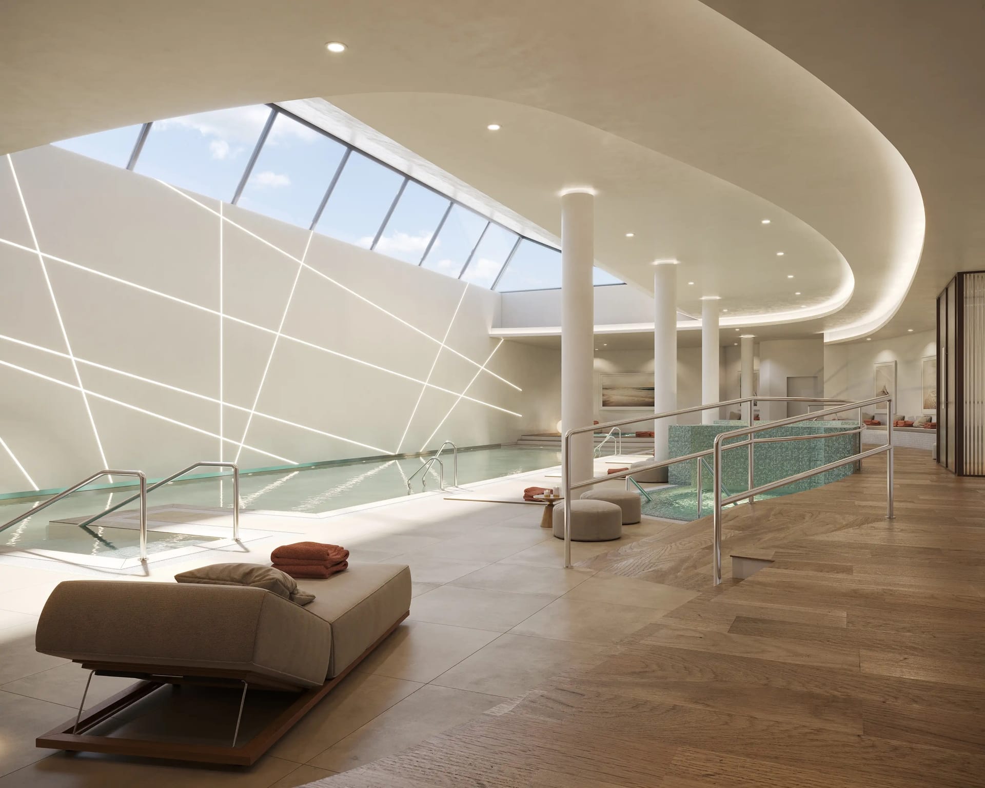 The spa, with a lounger on a timber floor beside the indoor pool and a long skylight overhead. Vanian Gardens IV, La Resina, Estepona.