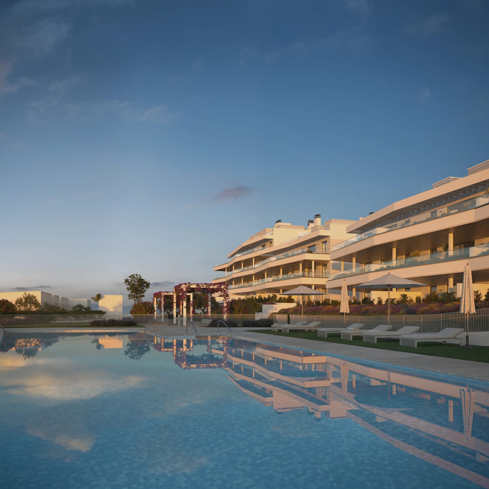 The pool at dusk, with the buildings and their terraces reflected in the water. Vanian Park, La Resina, Estepona.