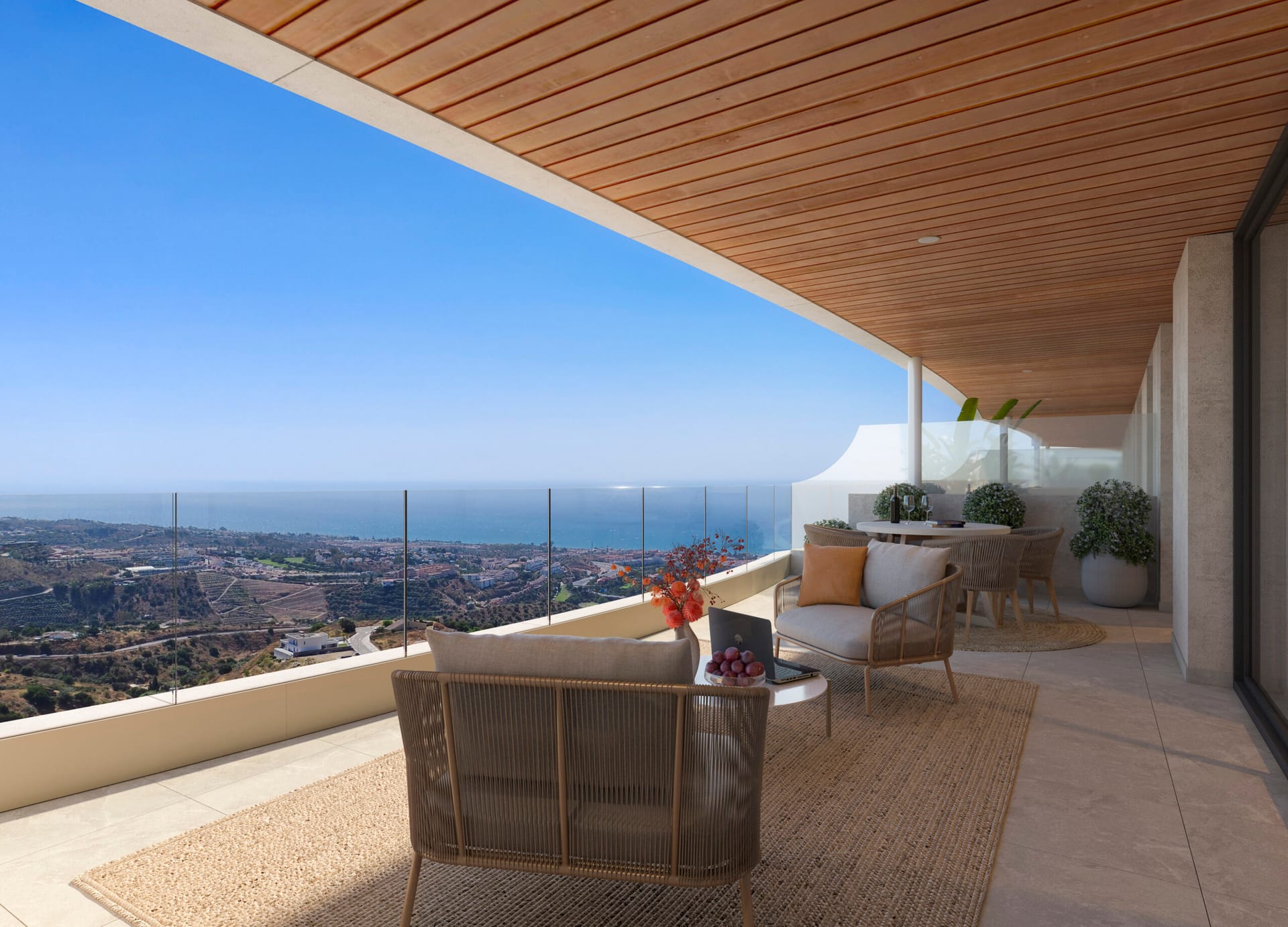 A covered first-floor terrace under a wooden ceiling, with the coast and the sea beyond the glass rail. Victoria Hills, Torre de Benagalbón, Rincón de la Victoria.