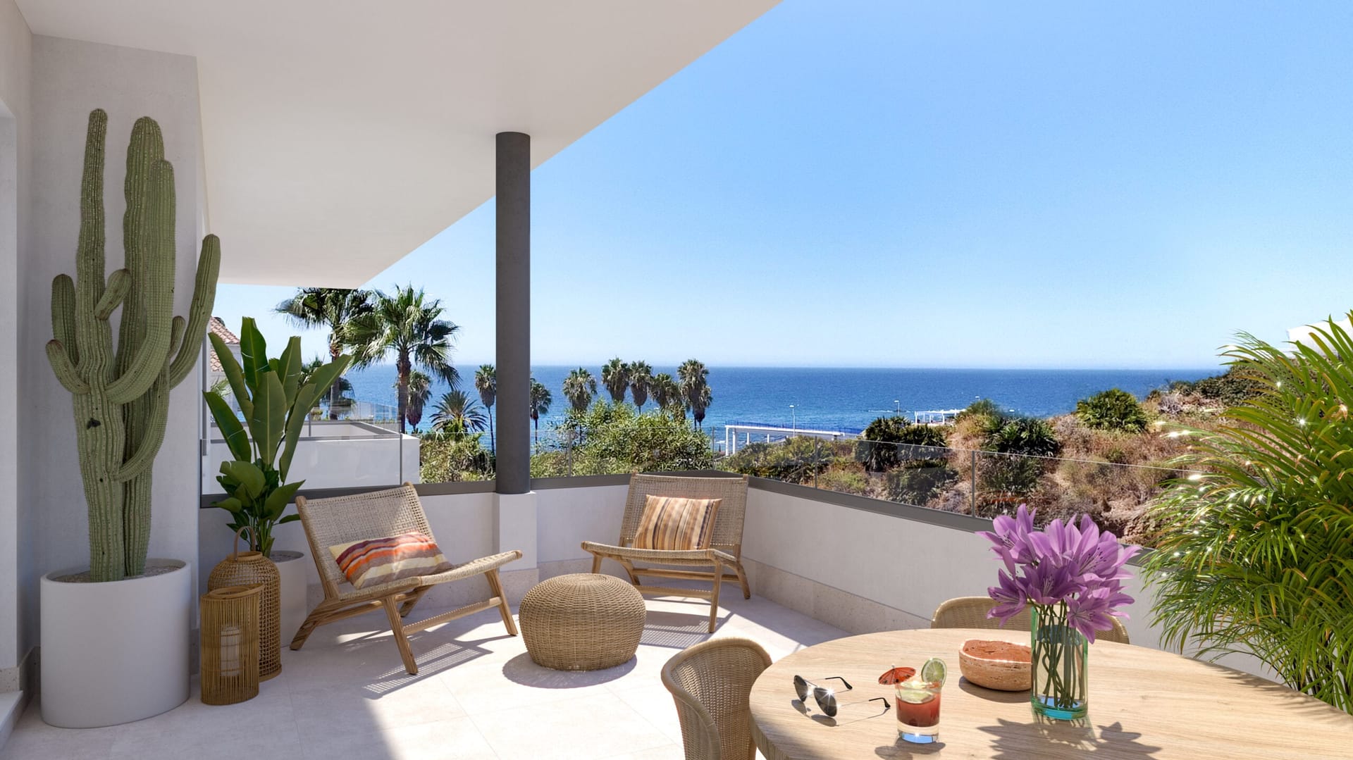 A covered terrace with planters and chairs, looking out over palms to the sea. Vitta Marina, El Chaparral, Mijas.
