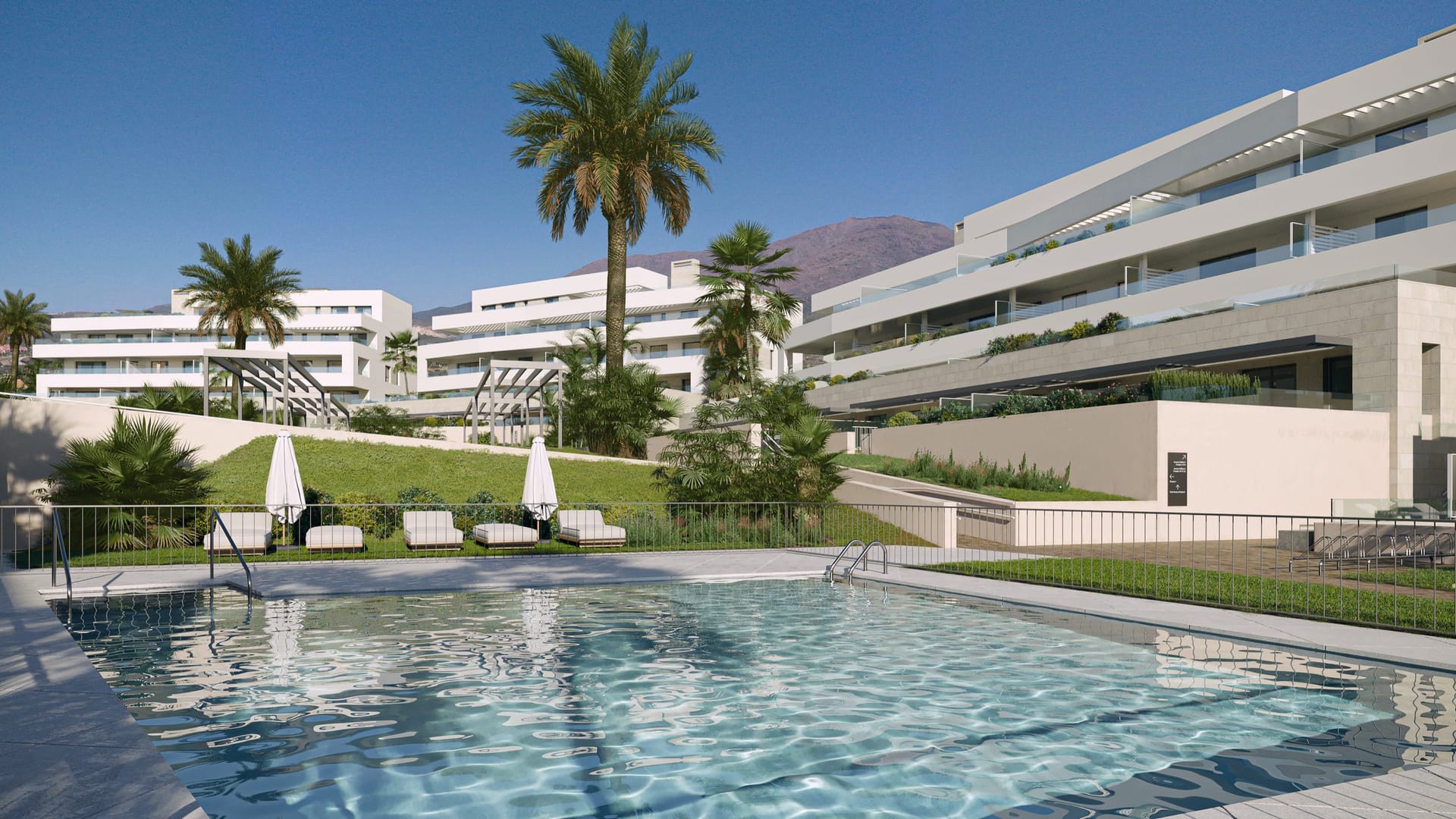 One of the pools, with a palm tree at the water’s edge and the buildings stepping up the slope behind. Zenity Blau II, La Gaspara, Estepona.