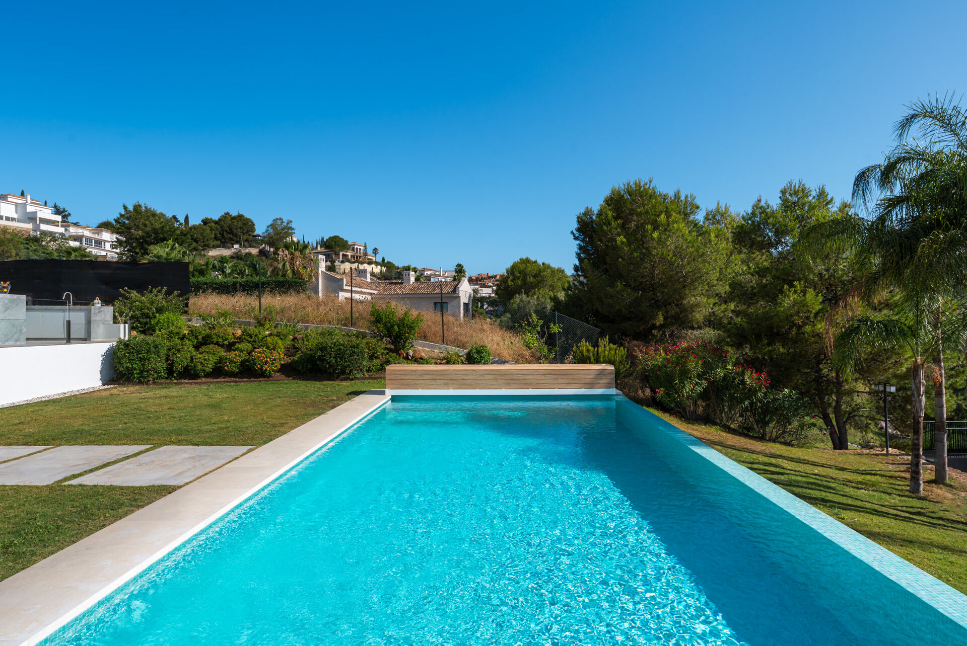 The swimming pool and the lawn behind the villa.