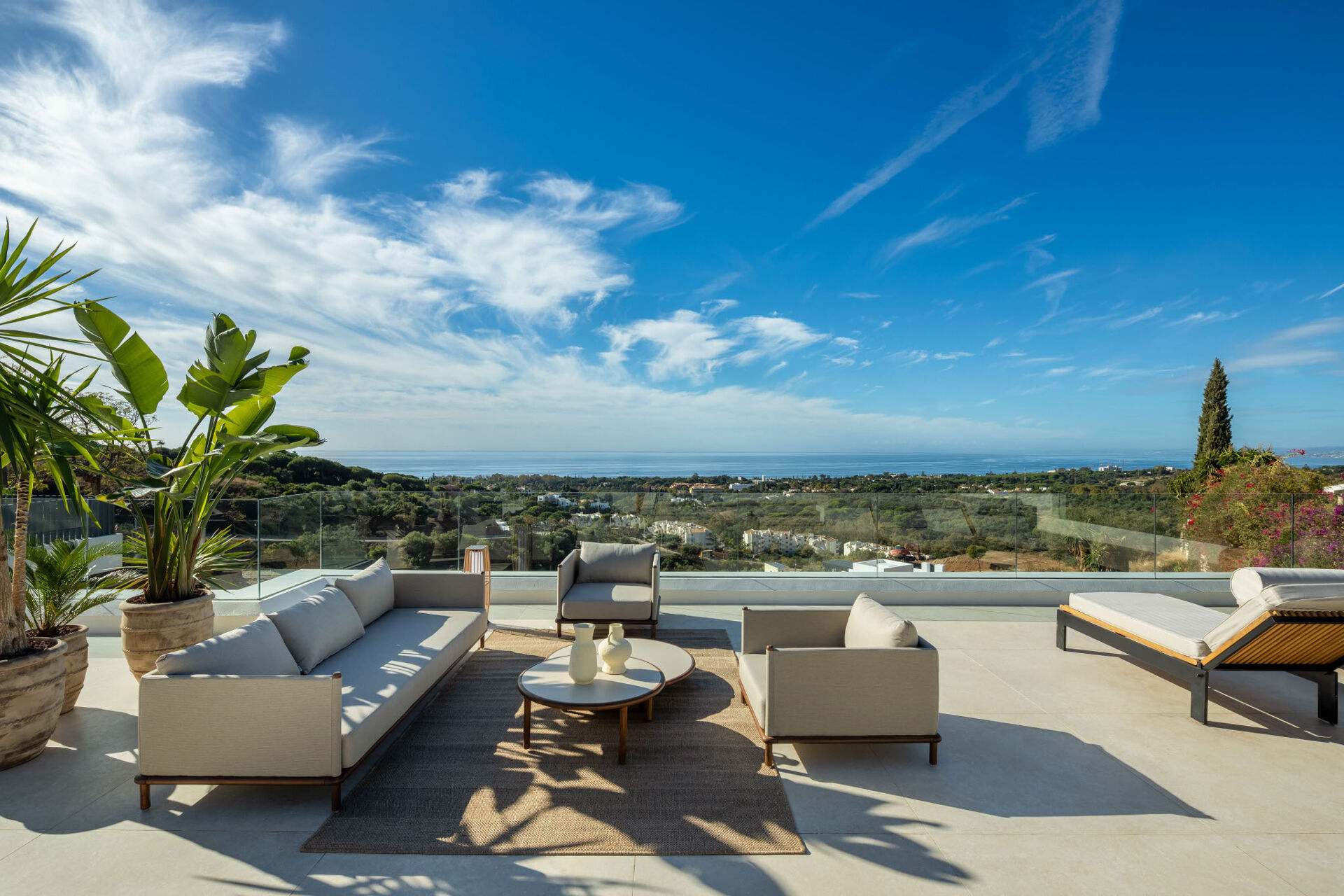 The upper terrace, with seating, looking over the hills and the coast to the sea.